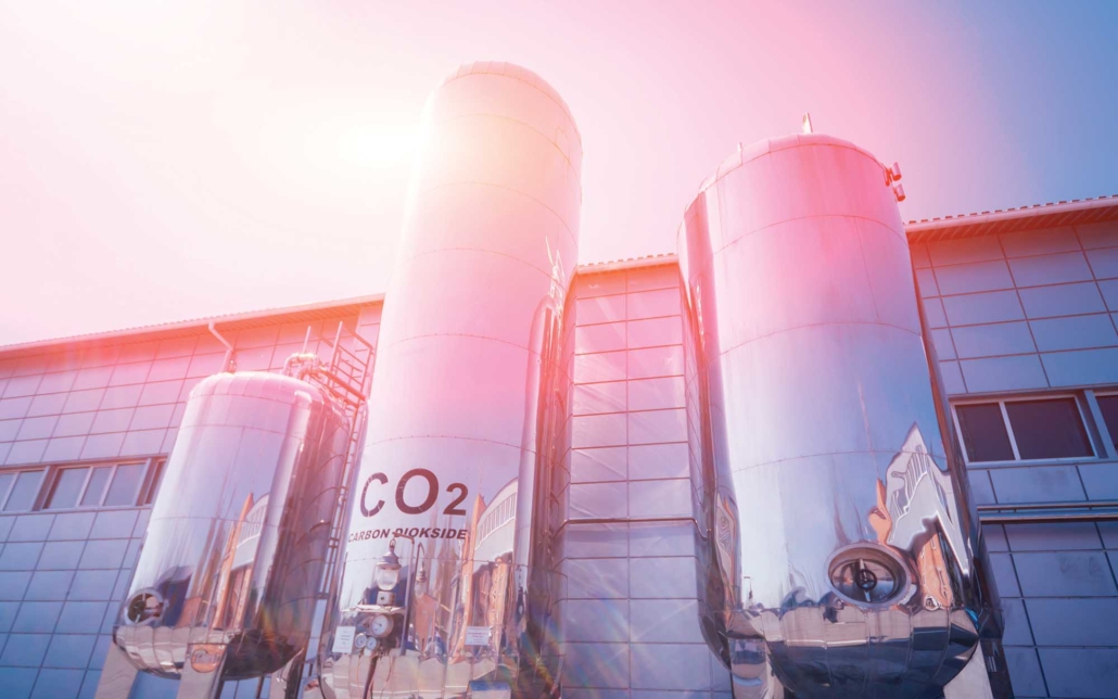 Industrial grade bulk co2 tank on the exterior of a large factory